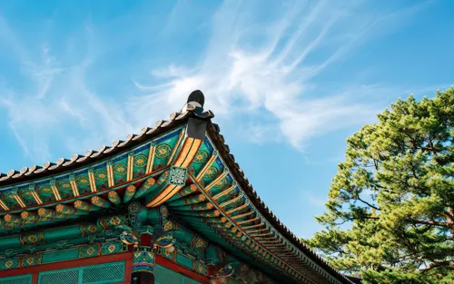 Colorful Korean temple roof beneath a blue sky